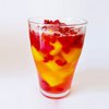 Party drink with frozen mango and pomegranate